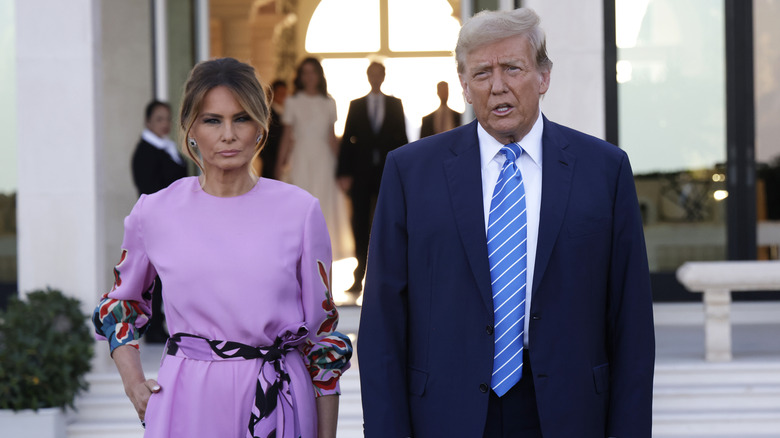 Donald Trump frowning beside Melania Trump