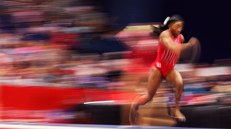 Blurry running shot of Simone Biles