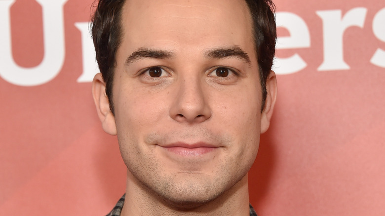 Skylar Astin posing