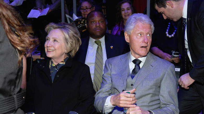 Bill and Hilary Clinton look in different directions