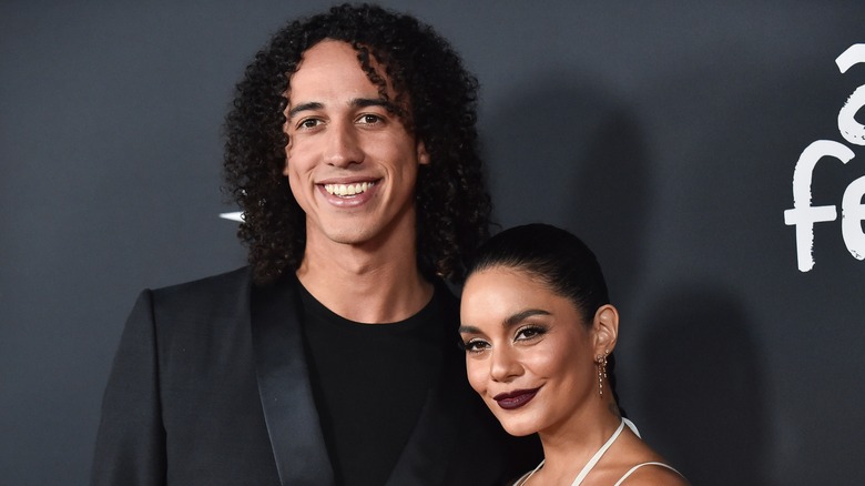 Vanessa Hudgens and Cole Tucker pose together on red carpet