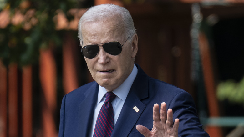 Joe Biden walking with sunglasses on