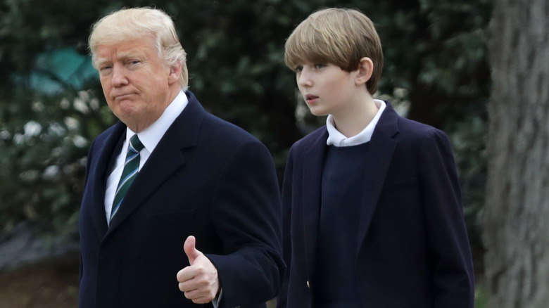 Donald Trump giving thumbs up beside Barron Trump