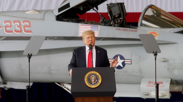 Donald Trump speaking in front of jet