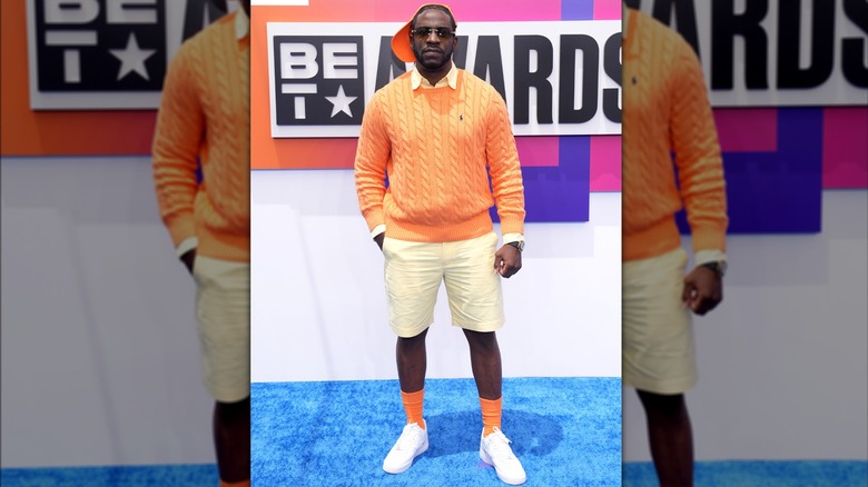 Young Dro wearing orange