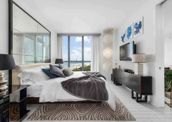 bedroom with windows overlooking the ocean
